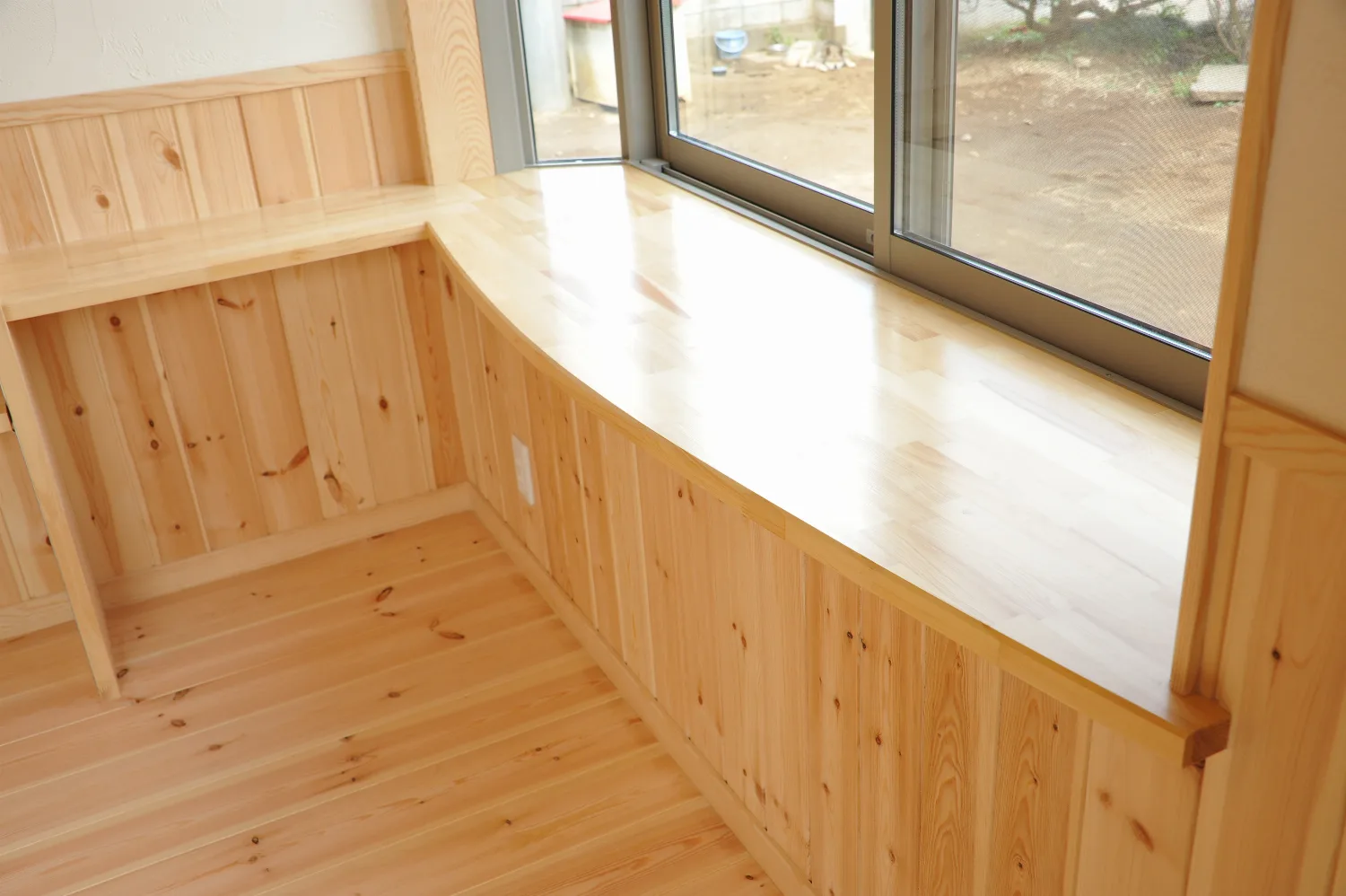 格子に組んだ梁と、壁一面の造作収納。パインに包まれた住まい
