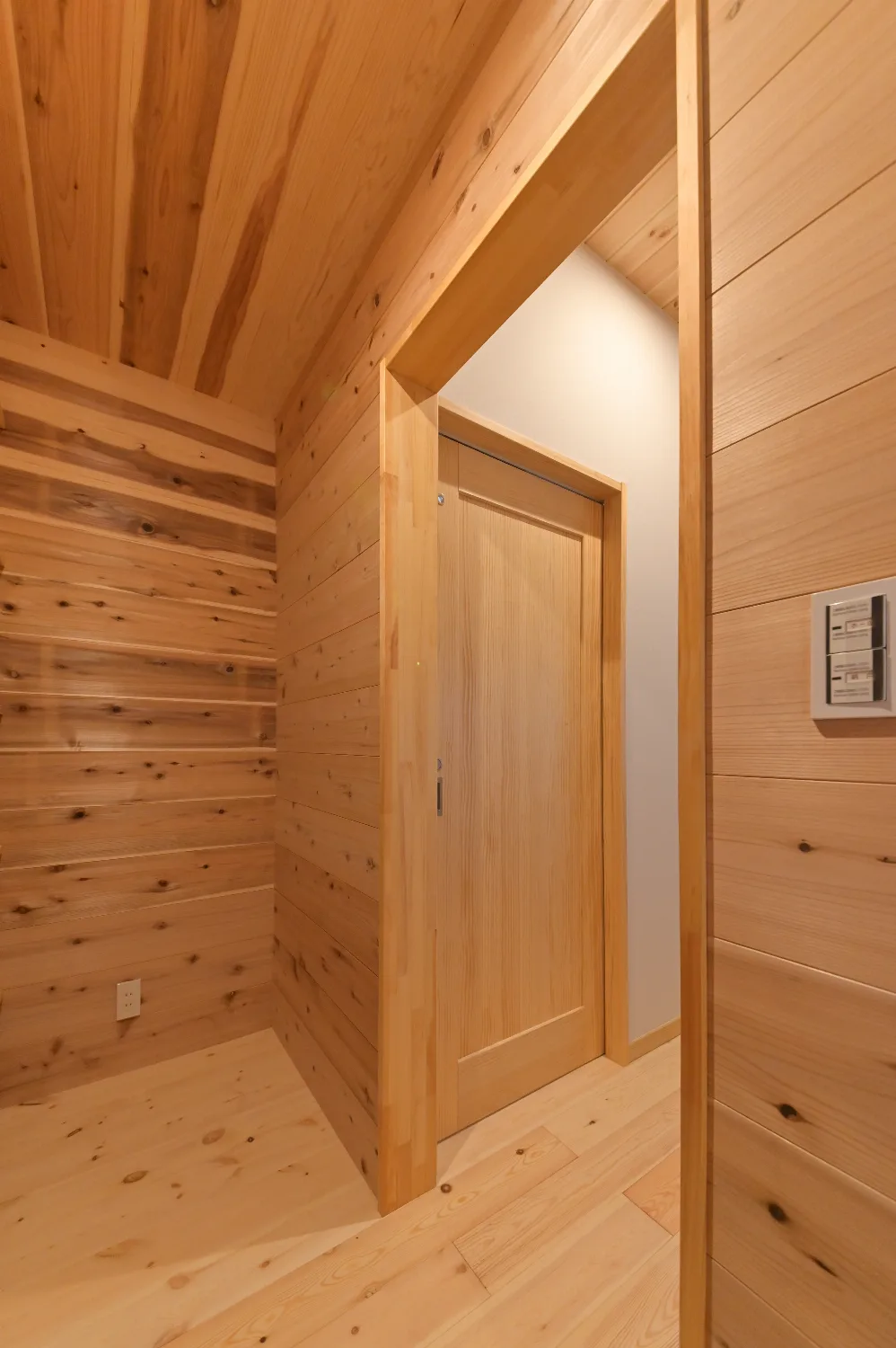 登り梁を見上げる平屋。ウッドデッキと太陽光を備えた住まい
